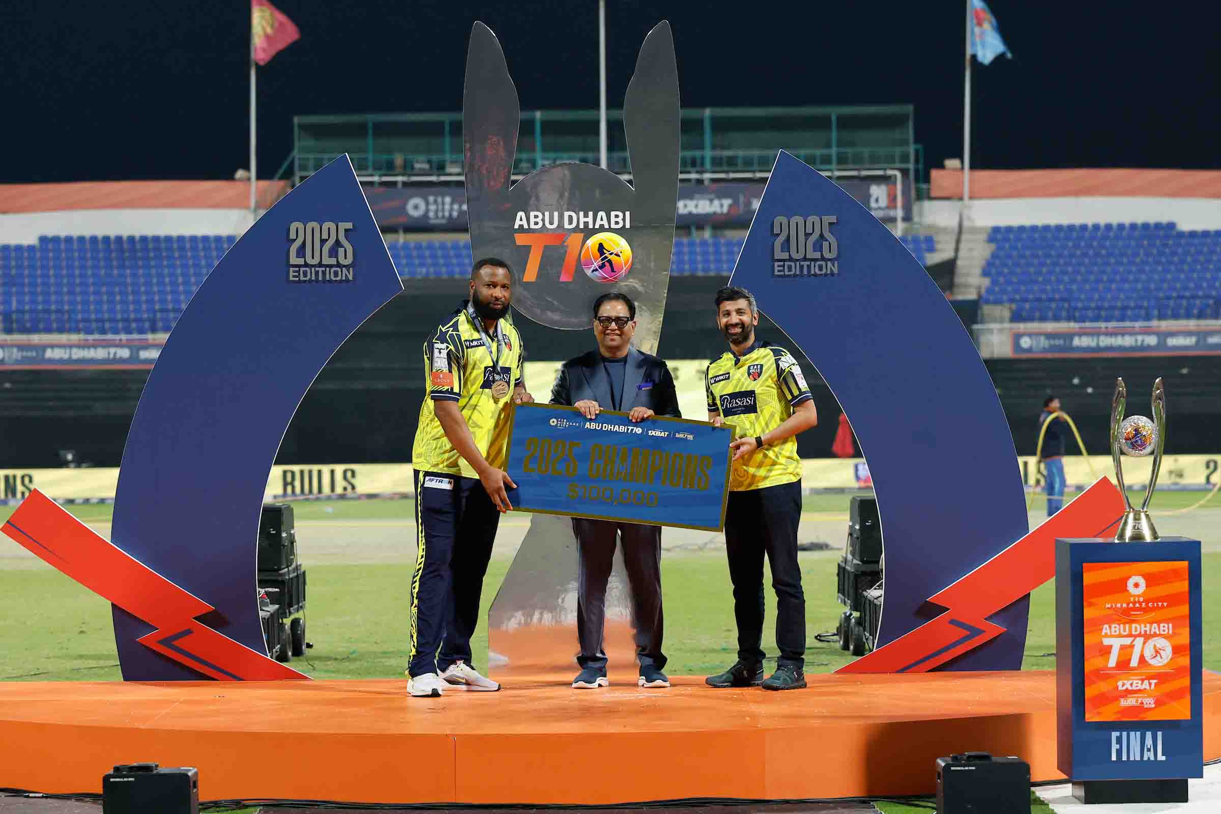 Kieron Pollard, captain of UAE Bulls, receives the champions trophy from Shaji Ul Mulk during the presentation ceremony following the Abu Dhabi T10 final between the Aspin Stallions and UAE Bulls at the Sheikh Zayed Cricket Stadium.